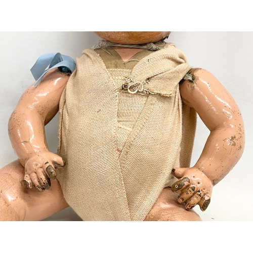 93 - An early 20th century doll. 35cm