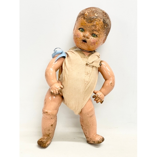 93 - An early 20th century doll. 35cm