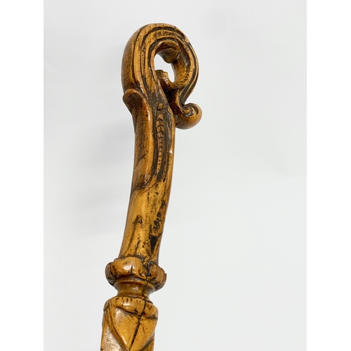 128 - A late 19th century North European carved fruitwood letter opener. 28cm