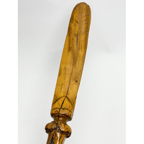 128 - A late 19th century North European carved fruitwood letter opener. 28cm