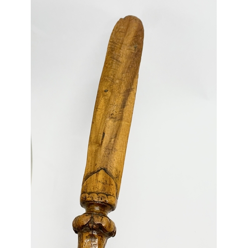 128 - A late 19th century North European carved fruitwood letter opener. 28cm