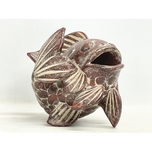 140 - A vintage oriental terracotta fish. 18x18cm.