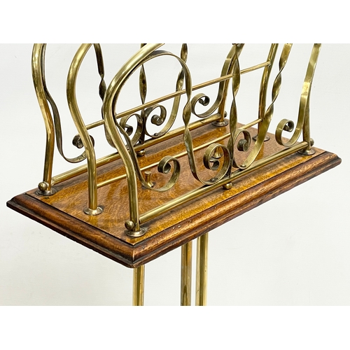 155 - A late Victorian brass and oak magazine rack. 33x74cm