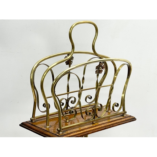 155 - A late Victorian brass and oak magazine rack. 33x74cm