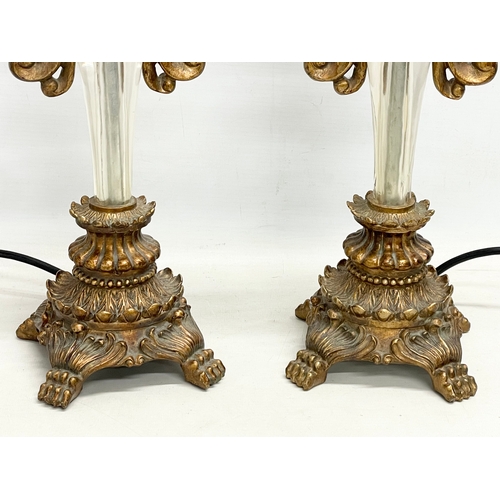 174 - A pair of ornate gilt table lamps. 66cm