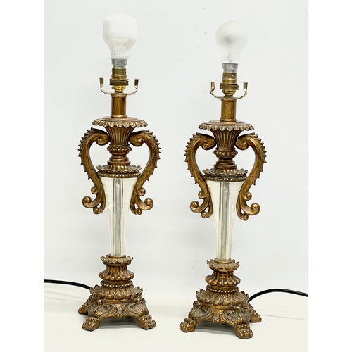 174 - A pair of ornate gilt table lamps. 66cm