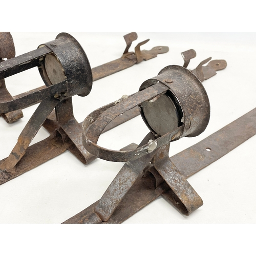 190 - 3 large 19th century iron wall hanging candleholders. 64cm