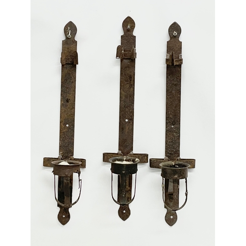 190 - 3 large 19th century iron wall hanging candleholders. 64cm