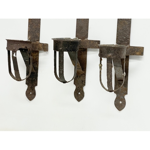 190 - 3 large 19th century iron wall hanging candleholders. 64cm