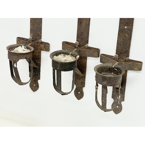 190 - 3 large 19th century iron wall hanging candleholders. 64cm