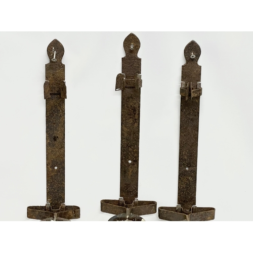 190 - 3 large 19th century iron wall hanging candleholders. 64cm