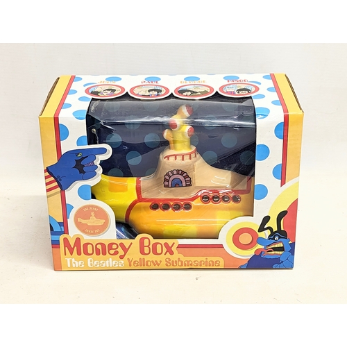 240 - A Puckator The Beatles Yellow Submarine Money Box. Box measures 25x13x17cm