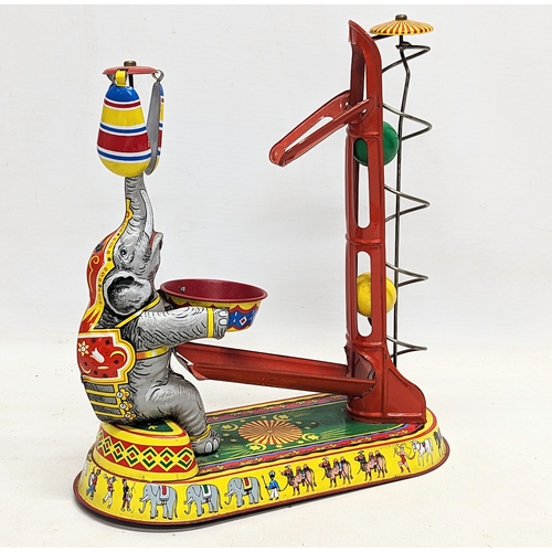 241 - A vintage tinplate clockwork circus elephant, in working order. Made in US Zone, Germany. 21.5x24.5c... 