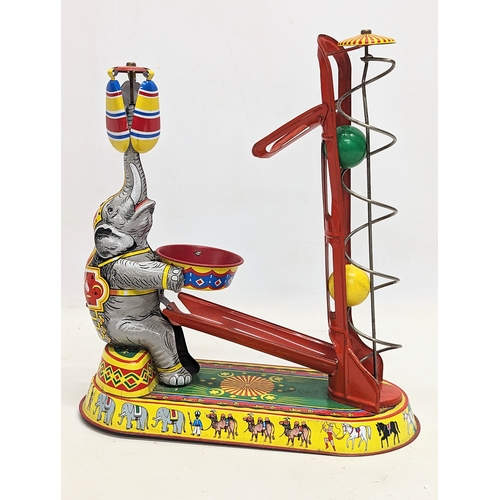 241 - A vintage tinplate clockwork circus elephant, in working order. Made in US Zone, Germany. 21.5x24.5c... 