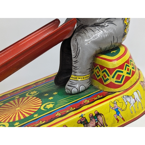 241 - A vintage tinplate clockwork circus elephant, in working order. Made in US Zone, Germany. 21.5x24.5c... 