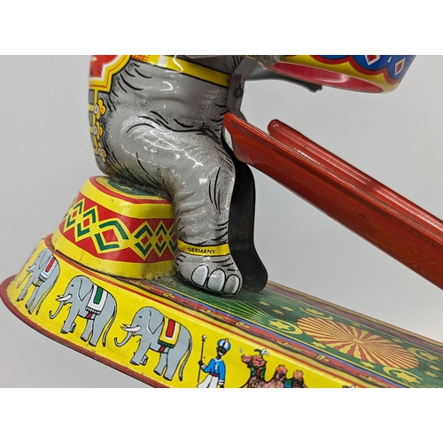 241 - A vintage tinplate clockwork circus elephant, in working order. Made in US Zone, Germany. 21.5x24.5c... 