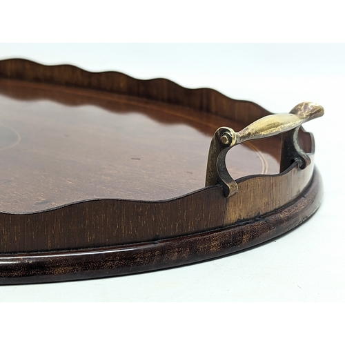 195 - An Edwardian inlaid mahogany serving tray with brass handles. 63x43.5cm