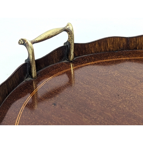 195 - An Edwardian inlaid mahogany serving tray with brass handles. 63x43.5cm