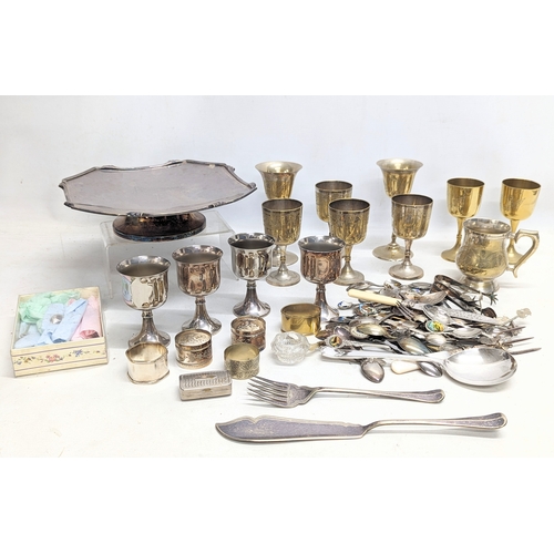 574 - A quantity of silver plate, including cutlery, drinking goblets, napkin rings, etc.