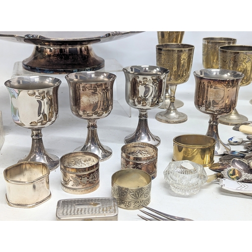 574 - A quantity of silver plate, including cutlery, drinking goblets, napkin rings, etc.