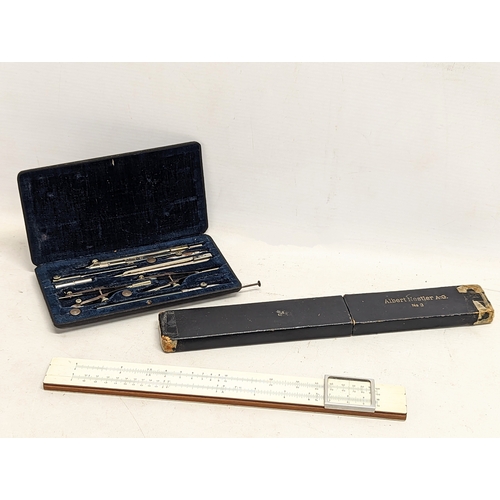 579 - A vintage drafting set, with a vintage slide ruler.