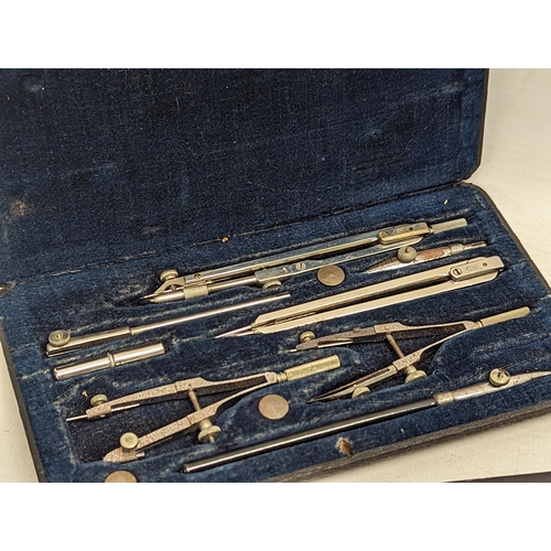 579 - A vintage drafting set, with a vintage slide ruler.