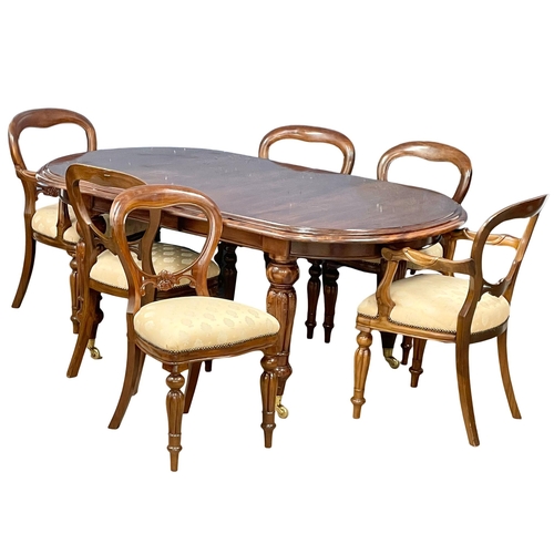 1014 - A good quality Victorian style mahogany extending dining table and 6 balloon back chairs. With winde... 