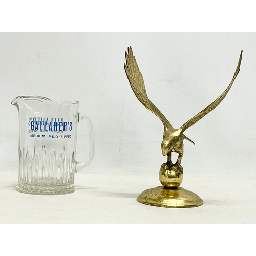 585 - A large vintage Gallaher’s glass jug and brass eagle. Eagle 21x26.5cm