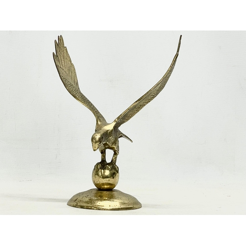 585 - A large vintage Gallaher’s glass jug and brass eagle. Eagle 21x26.5cm