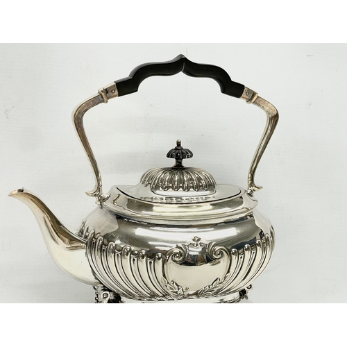 14 - A 5 piece silver plated tea service. Including a spirit kettle 23x30cm. A coffee pot 24.5x24cm. Teap... 