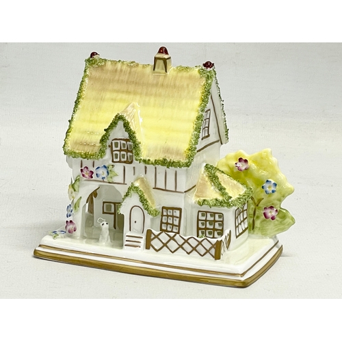 66 - A collection of Coalport pottery houses. The Farmhouse 20cm. The Master’s House 11x10.5cm. Limited E... 