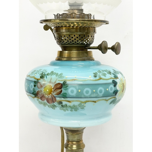 28 - A large Victorian double burner electrified oil lamp with hand painted glass bowl and brass column. ... 