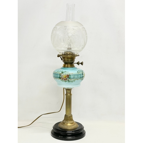 28 - A large Victorian double burner electrified oil lamp with hand painted glass bowl and brass column. ... 