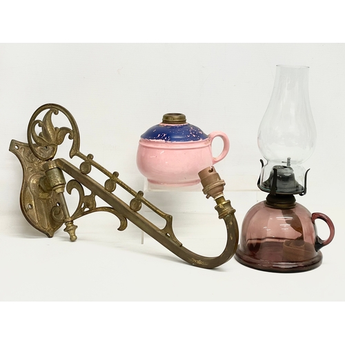 75 - 2 late 19th century glass and pottery finger oil lamps and a large brass wall light.