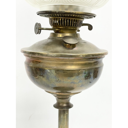 29 - A tall Victorian brass double burner oil lamp with later glass shade. 62cm