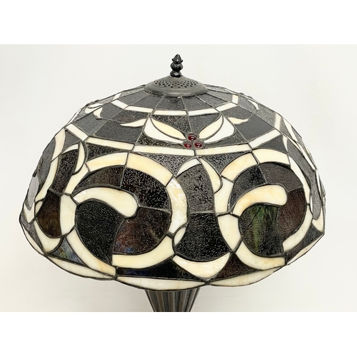 76 - A large Tiffany style table lamp. Shade measures 52x30cm. Base 48cm.