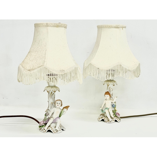 78 - A pair of Von Schierholz porcelain cherub lamps. PMP. 36cm