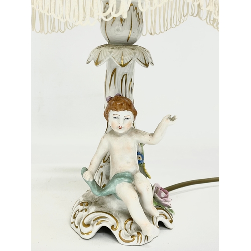 78 - A pair of Von Schierholz porcelain cherub lamps. PMP. 36cm