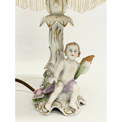 78 - A pair of Von Schierholz porcelain cherub lamps. PMP. 36cm