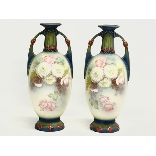 79 - A pair of Austrian hand painted porcelain vases by Robert Hanke for Royal Wettina. Circa 1900. 28cm