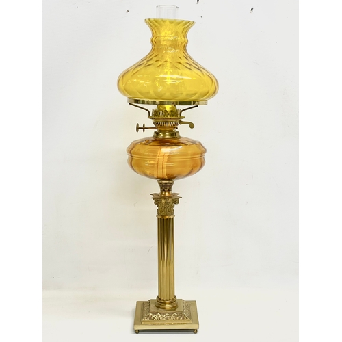 82 - A large Victorian style double burner oil lamp with Amber Glass bowl, brass Corinthian style column ... 