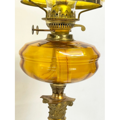 82 - A large Victorian style double burner oil lamp with Amber Glass bowl, brass Corinthian style column ... 