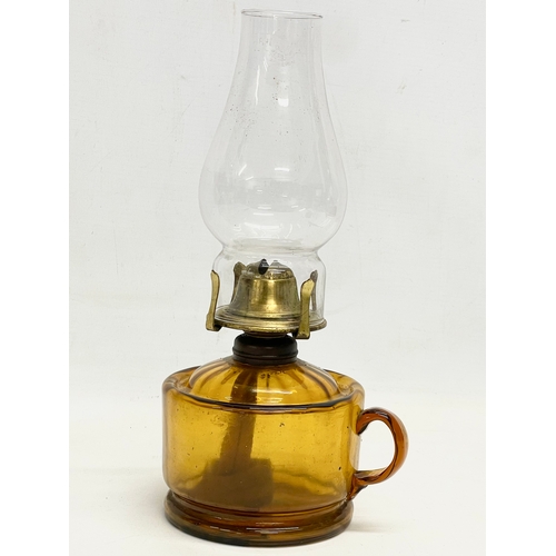 84 - A late Victorian Amber Glass finger oil lamp. 14x28cm