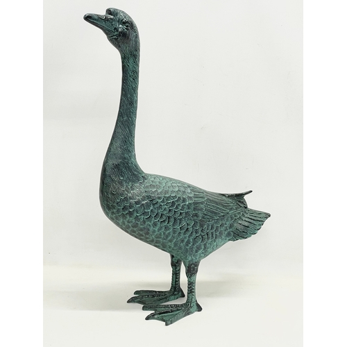 90 - A large cast alloy garden goose figure. 49x72cm