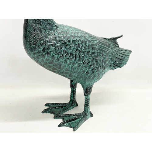 90 - A large cast alloy garden goose figure. 49x72cm