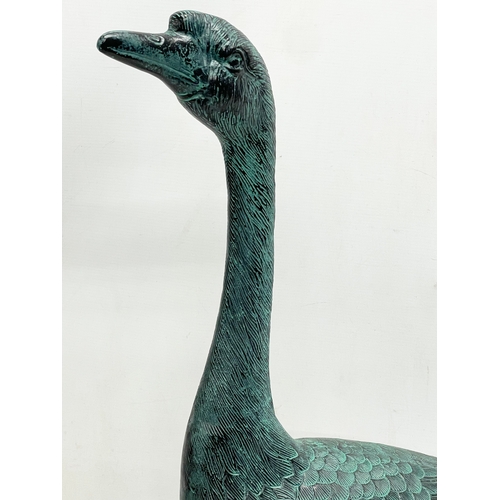 90 - A large cast alloy garden goose figure. 49x72cm