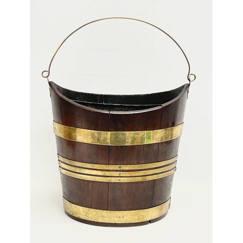 40 - A George III brass bound mahogany peat bucket with original liner. Circa 1800. 37x27x37cm