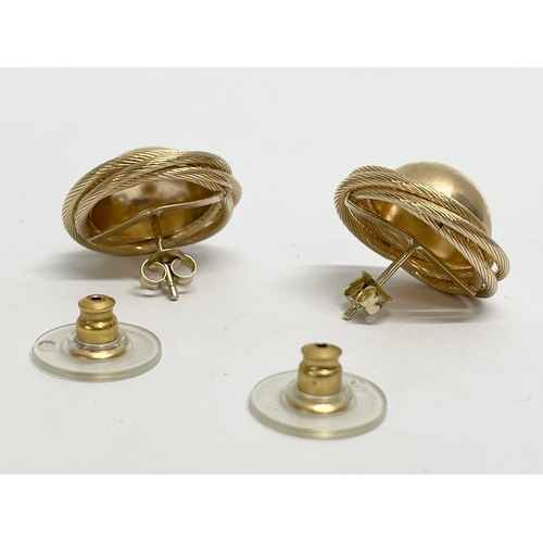 136 - A pair of 9ct gold earrings.