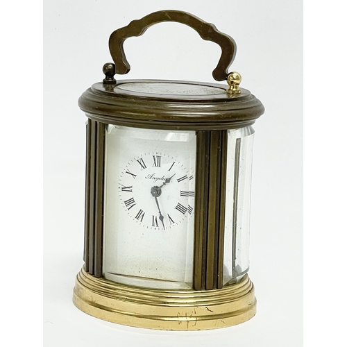 96 - A small vintage French brass carriage clock. Angelus. 7x8cm