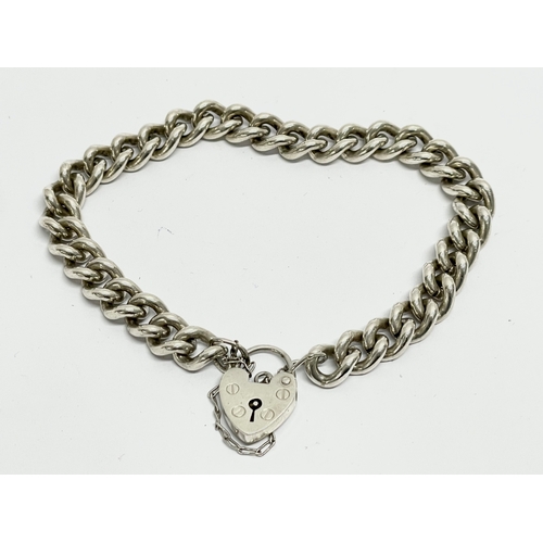 159 - A sterling silver heart lock bracelet. 31.40 grams.